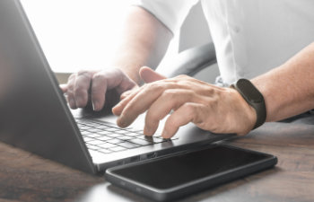 hand typing on laptop keyboard